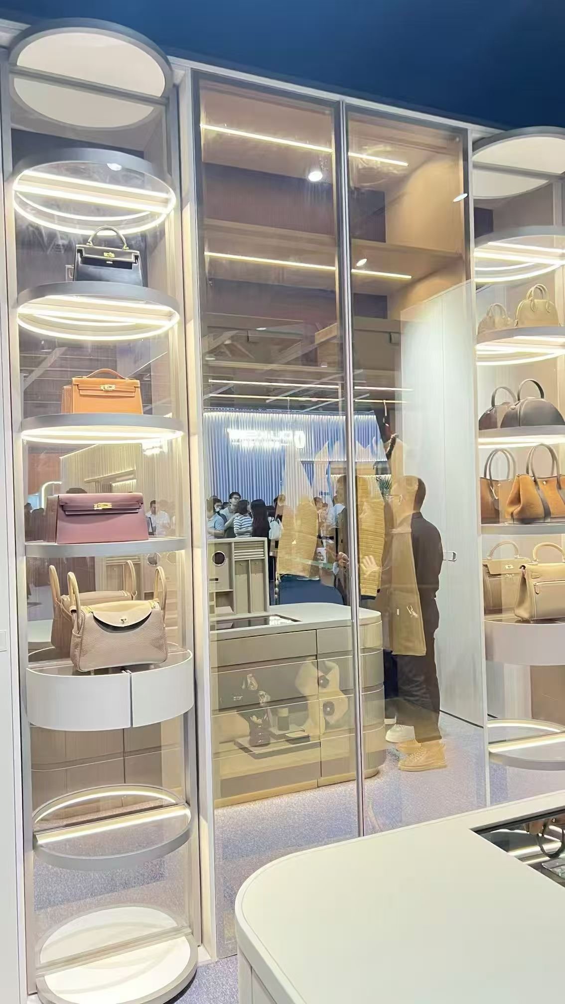 Luxury glass handbag display cabinet in walk-in closet